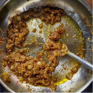 A pan of sauteeing onions for butter chicken recipe