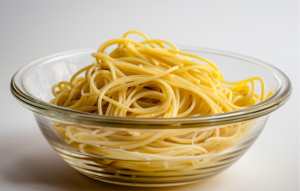 A bowl of cooked spaghetti, ready to be transformed into a delicious chicken tetrazzini recipe