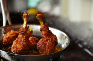 Chicken lollipop frying in a hot pan with golden brown coating