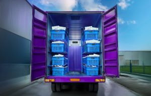 Refrigerated truck with open door showing meat slabs inside- A food safety measure