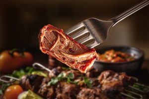 Close-up of a perfectly juicy piece of medium-rare mutton held with a fork- faster-cooking mutton